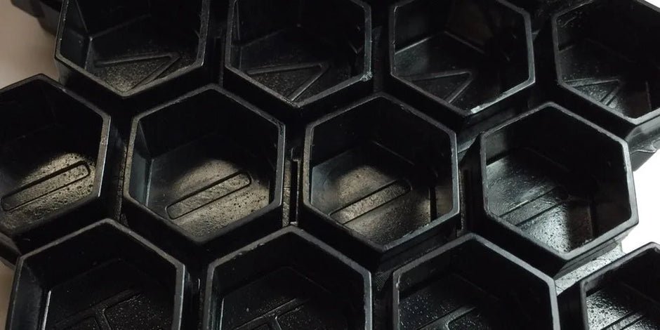 close up of hive caps hexagon cup shape in black