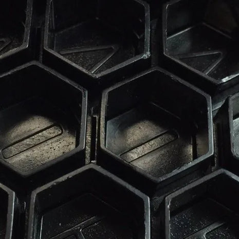 close up of hive caps hexagon cup shape in black
