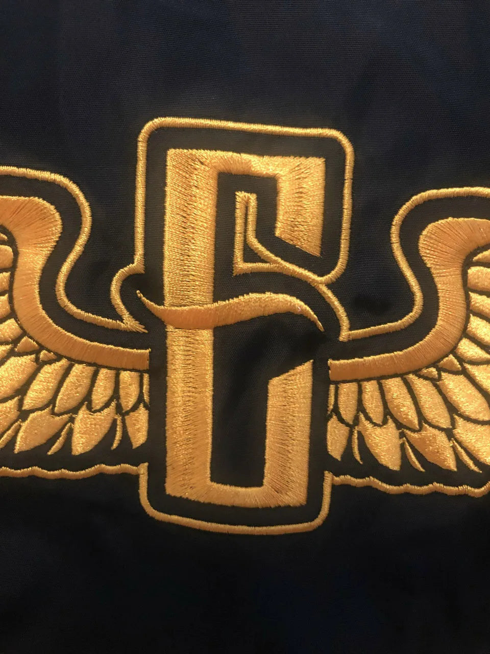 close up of the gold stitched detail on the electrum bomber jacket