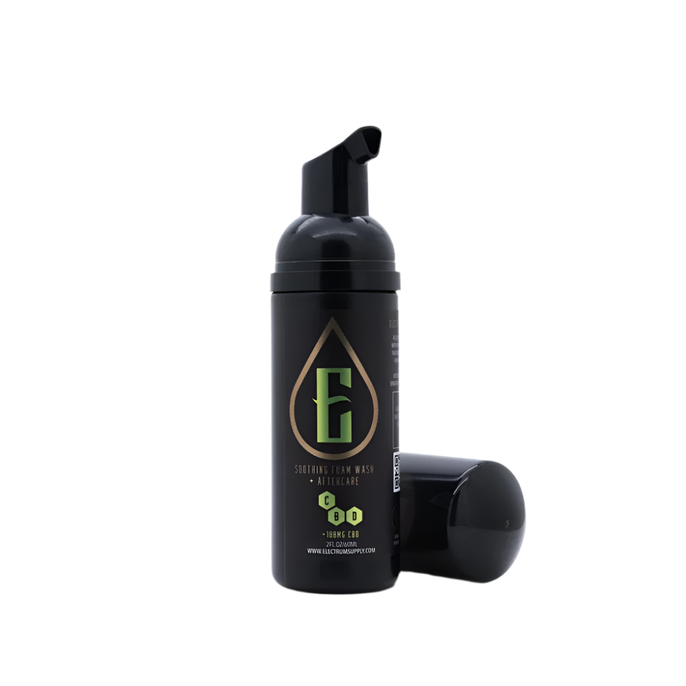 A black pump bottle with a green and yellow label, branded as 'Electrum', containing tattoo aftercare solution.