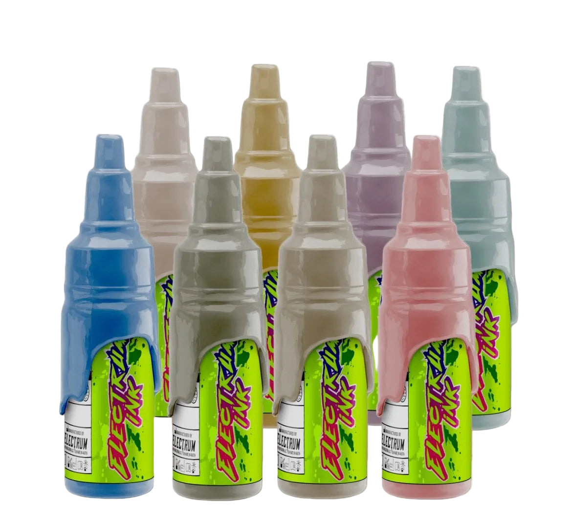 A set of various colored tattoo ink bottles, labeled with the Electrum brand and Janelle Hanson's Cowpoke collection.