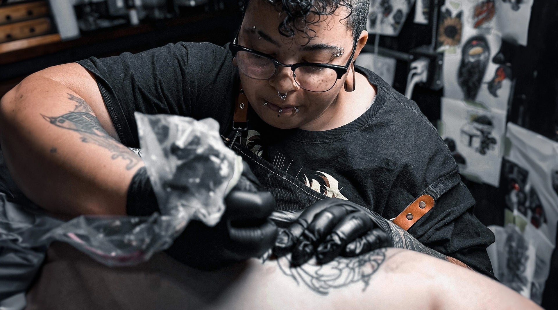 Queer female BIPOC artist using electrum tattoo supply gloves