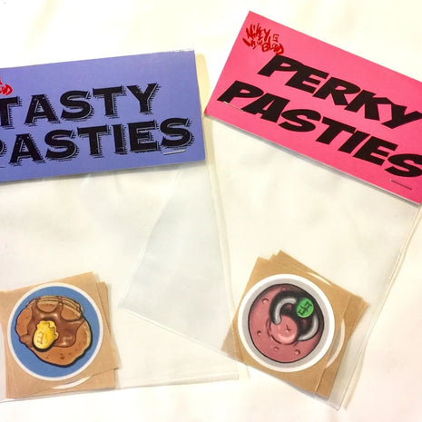 When censorship required - Two packs of disposable pasties, one labeled 'TASTY PASTIES' with an image of a bacon and egg design, and one labeled 'PERKY PASTIES' with a pancakes and waffles design.