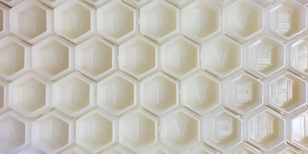 close up of hive caps hexagon cups in white
