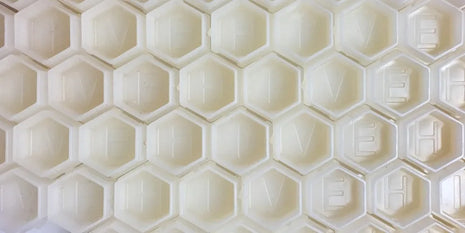 close up of hive caps hexagon cups in white
