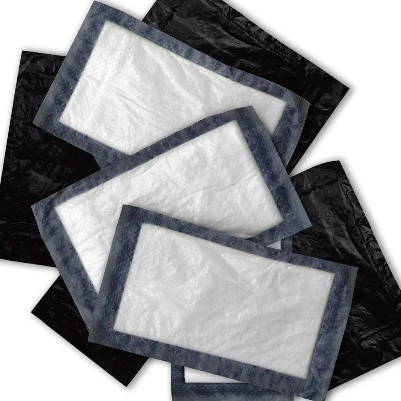 A pile of black tattoo soaker pads with a clear central area, arranged in a overlapping fashion.