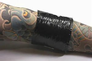 Black 'soaker' pads used to collect fluids after a tattoo