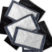 A pile of black tattoo soaker pads with a clear central area, arranged in a overlapping fashion.
