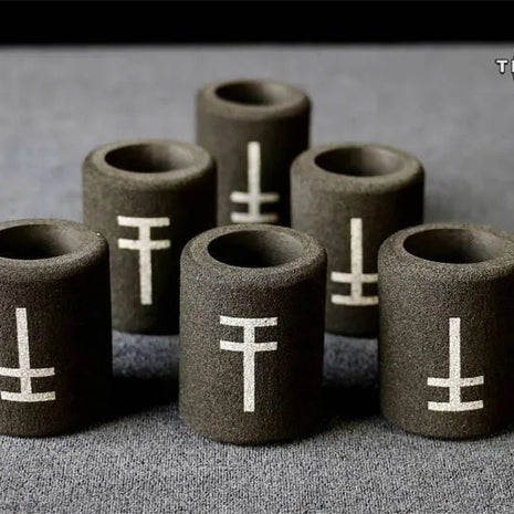 A collection of black disposable memory foam grip covers for tattooing, with the brand logo 'True Grips' visible in the top right corner.