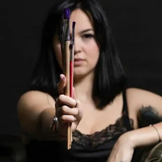 girl holding paint brushes?