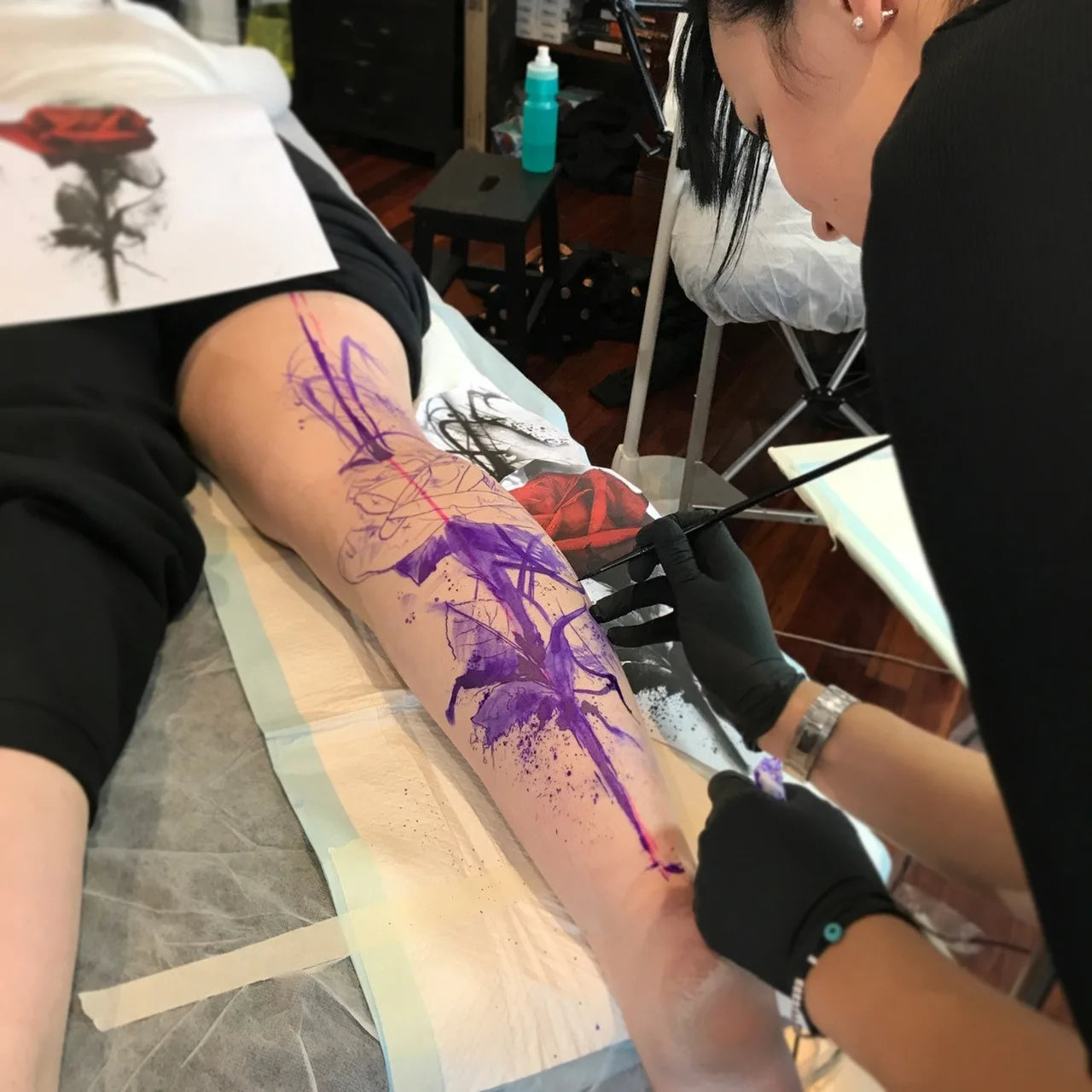 photo of arm being painted using violet ink