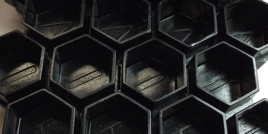 close up of hive caps hexagon cup shape in black
