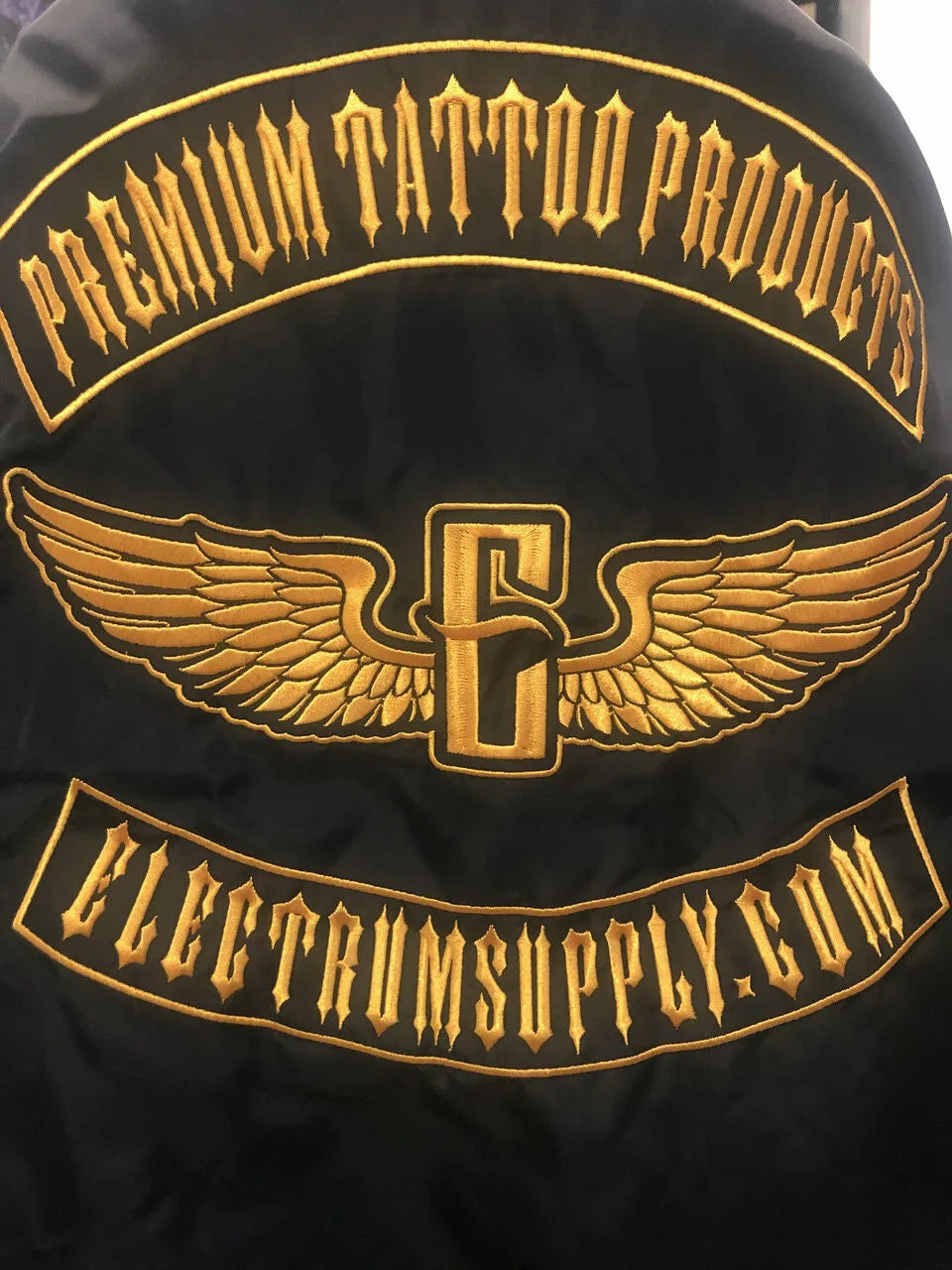 close up of the stitching on the electrum bomber jacket featuring the flying e design
