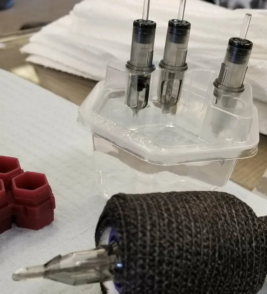 tattoo setup featuring hive cups rinse cup and cartridge holder