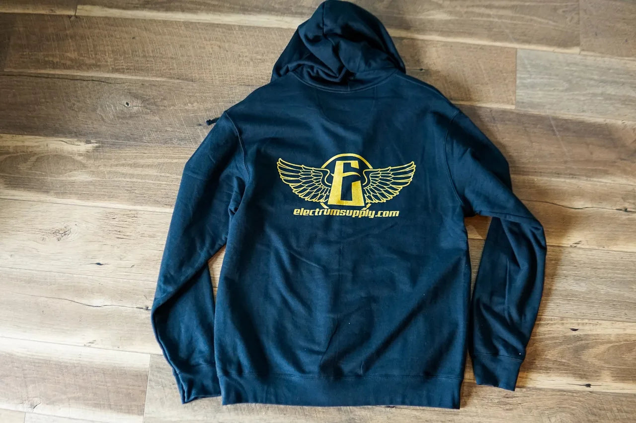A blue zip-up hoodie with a gold shimmering ink design on the back, featuring a tattoo supply company logo.