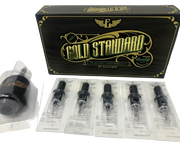 A box labeled 'Gold Standard' by Electrum, containing a variety of tattooing needle cartridges displayed in front of the box.