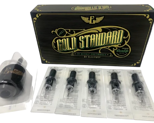 A box labeled 'Gold Standard' by Electrum, containing a variety of tattooing needle cartridges displayed in front of the box.