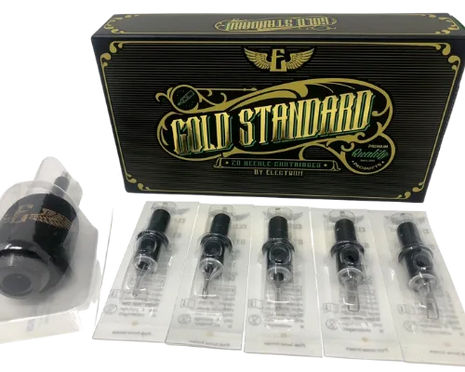A box labeled 'Gold Standard' by Electrum, containing a variety of tattooing needle cartridges displayed in front of the box.