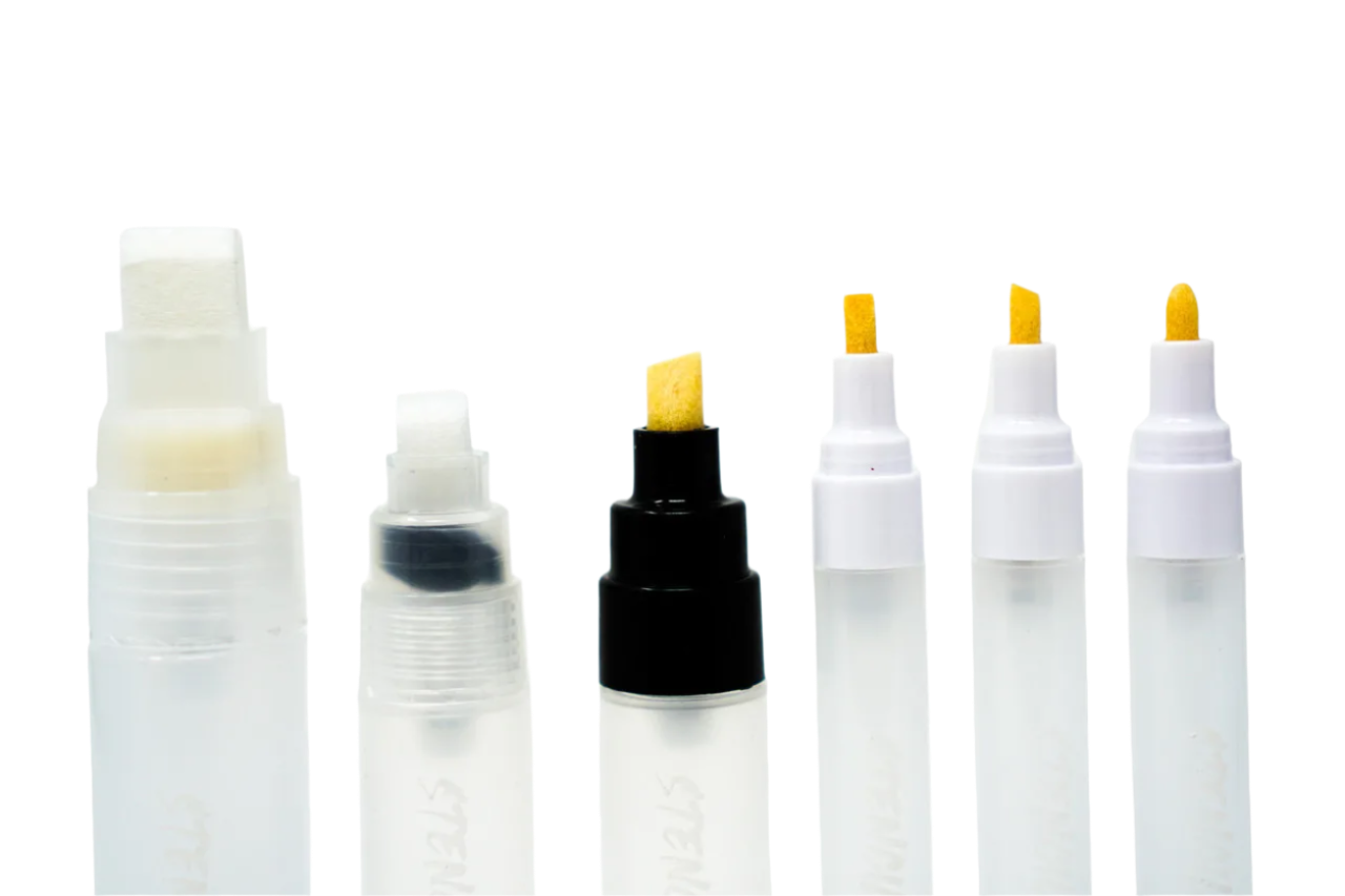A collection of Electrum refillable stencil lettering markers with various replacement tips, including flat, chisel, and bullet, displayed on a white background.