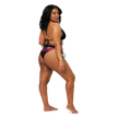 Woman wearing a black and pink bikini with 'Electrum' branding from the back