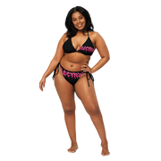 Woman wearing a black and pink bikini with 'Electrum' branding 