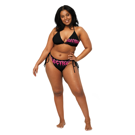 Woman wearing a black and pink bikini with 'Electrum' branding 