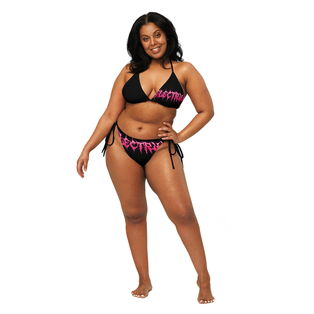 Woman wearing a black and pink bikini with 'Electrum' branding 