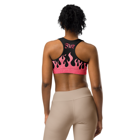 Person wearing a pink and black sports bra with flames and a fire cartridge logo on back