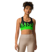 person wearing a black and green sports bra with a fire logo and fire print
