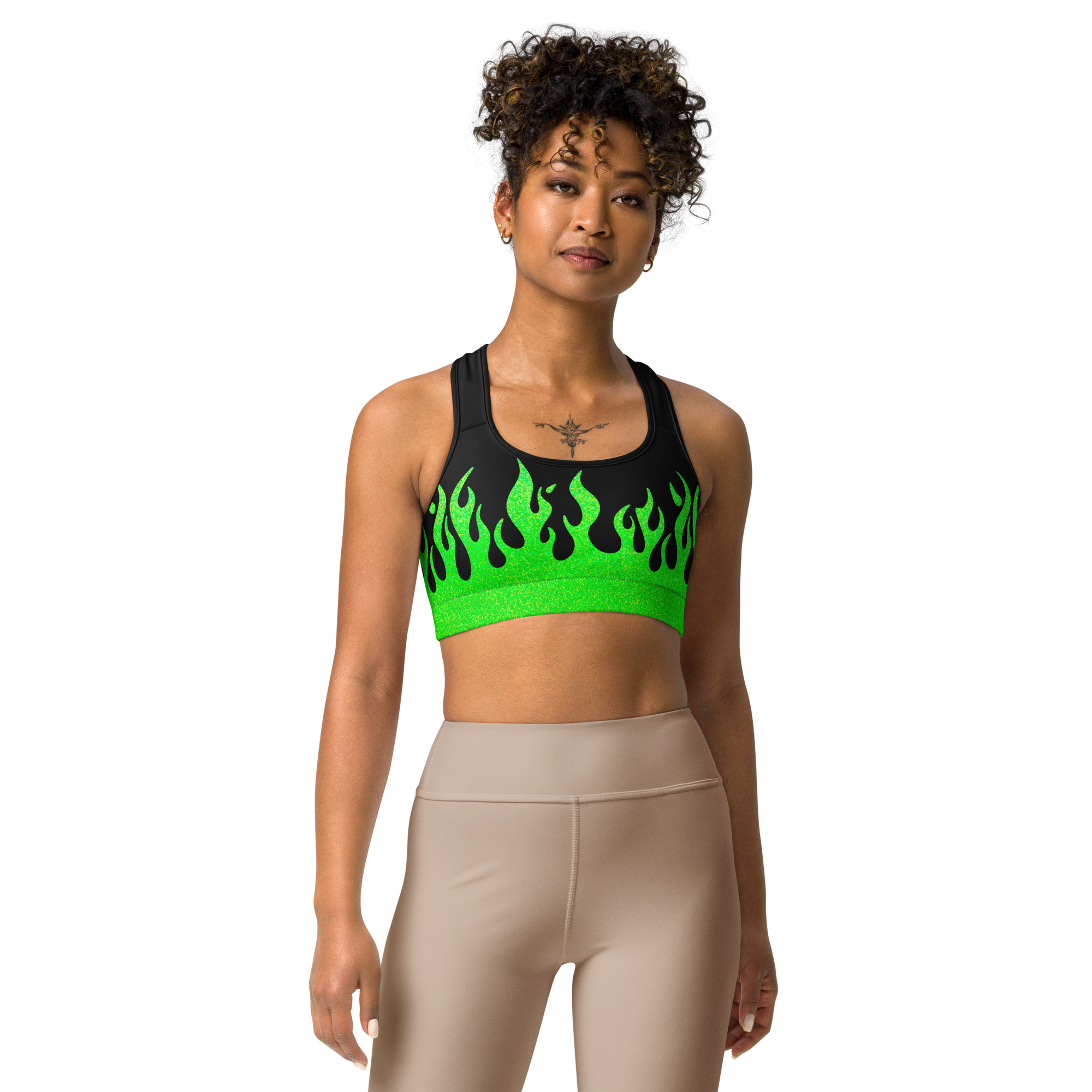 person wearing a black and green sports bra with a fire logo and fire print
