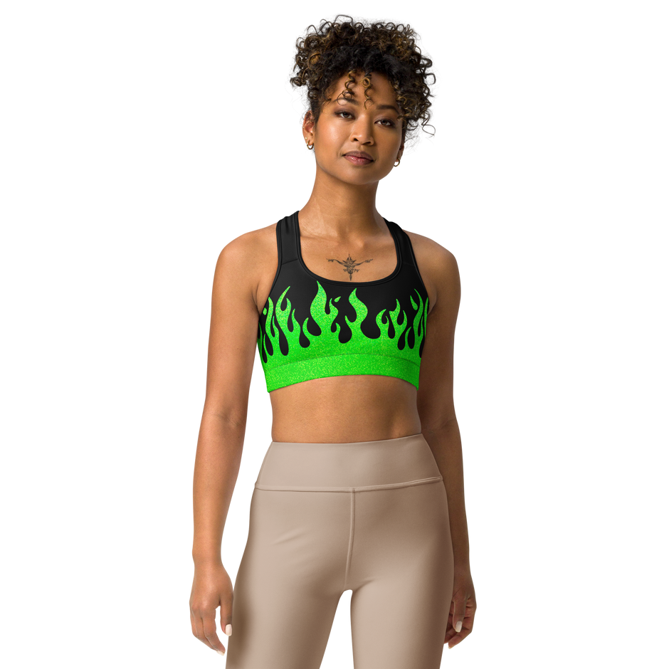 person wearing a black and green sports bra with a fire logo and fire print
