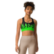 person wearing a black and green sports bra with a fire logo and fire print
