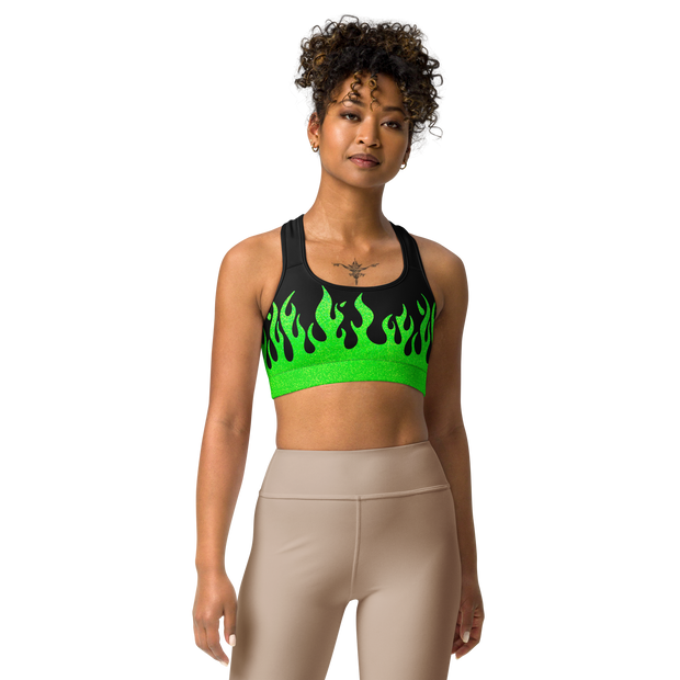 person wearing a black and green sports bra with a fire logo and fire print
