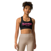 Woman wearing a black sports bra with pink metal lettering saying electrum tattoo supply