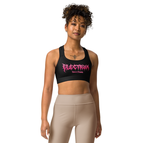 Woman wearing a black sports bra with pink metal lettering saying electrum tattoo supply