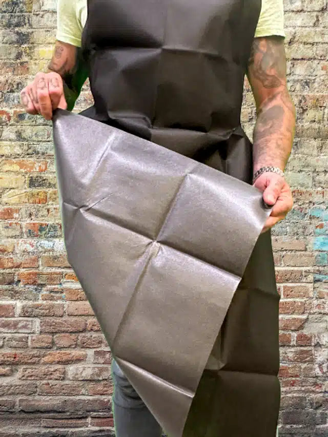 Artist wearing a single-use apron showing back side of  apron