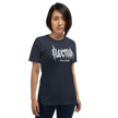 Person wearing a blue t-shirt with white text saying electrum tattoo supply in a metal inspired font