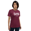 Person wearing a red t-shirt with white text saying electrum tattoo supply in a metal inspired font